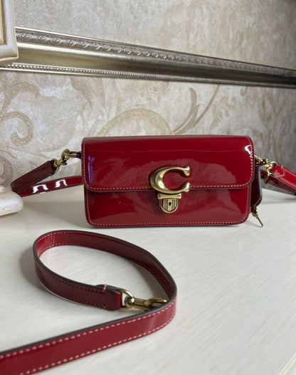 Heritage Compact Shoulder Bag in Glossy Crimson with Sculpted Gold Emblem