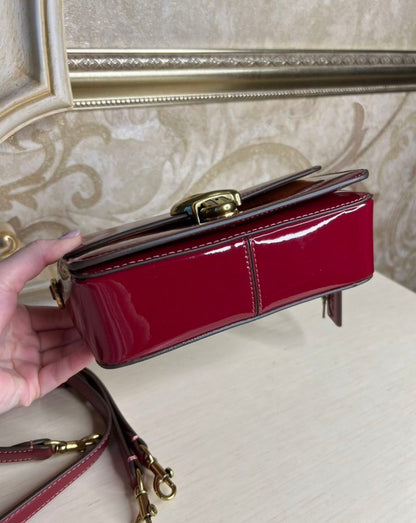 Heritage Compact Shoulder Bag in Glossy Crimson with Sculpted Gold Emblem