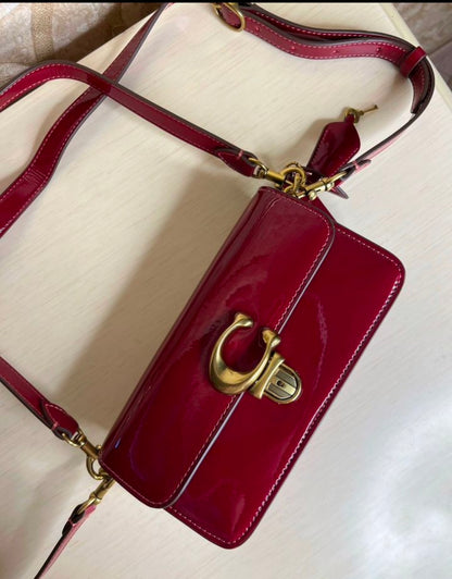Heritage Compact Shoulder Bag in Glossy Crimson with Sculpted Gold Emblem